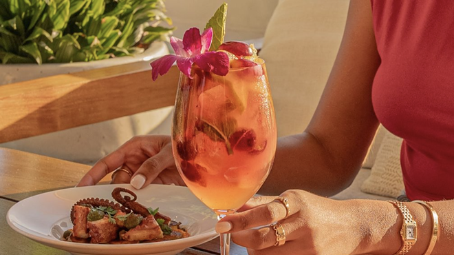 a hand holding a drink